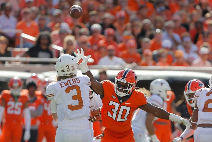 Oklahoma State Cowboys defensive end Collin Oliver (30) puts pressure on Texas Longhorns quarterback Quinn Ewers (3) during a college football game between the Oklahoma State Cowboys (OSU) and the University of Texas
